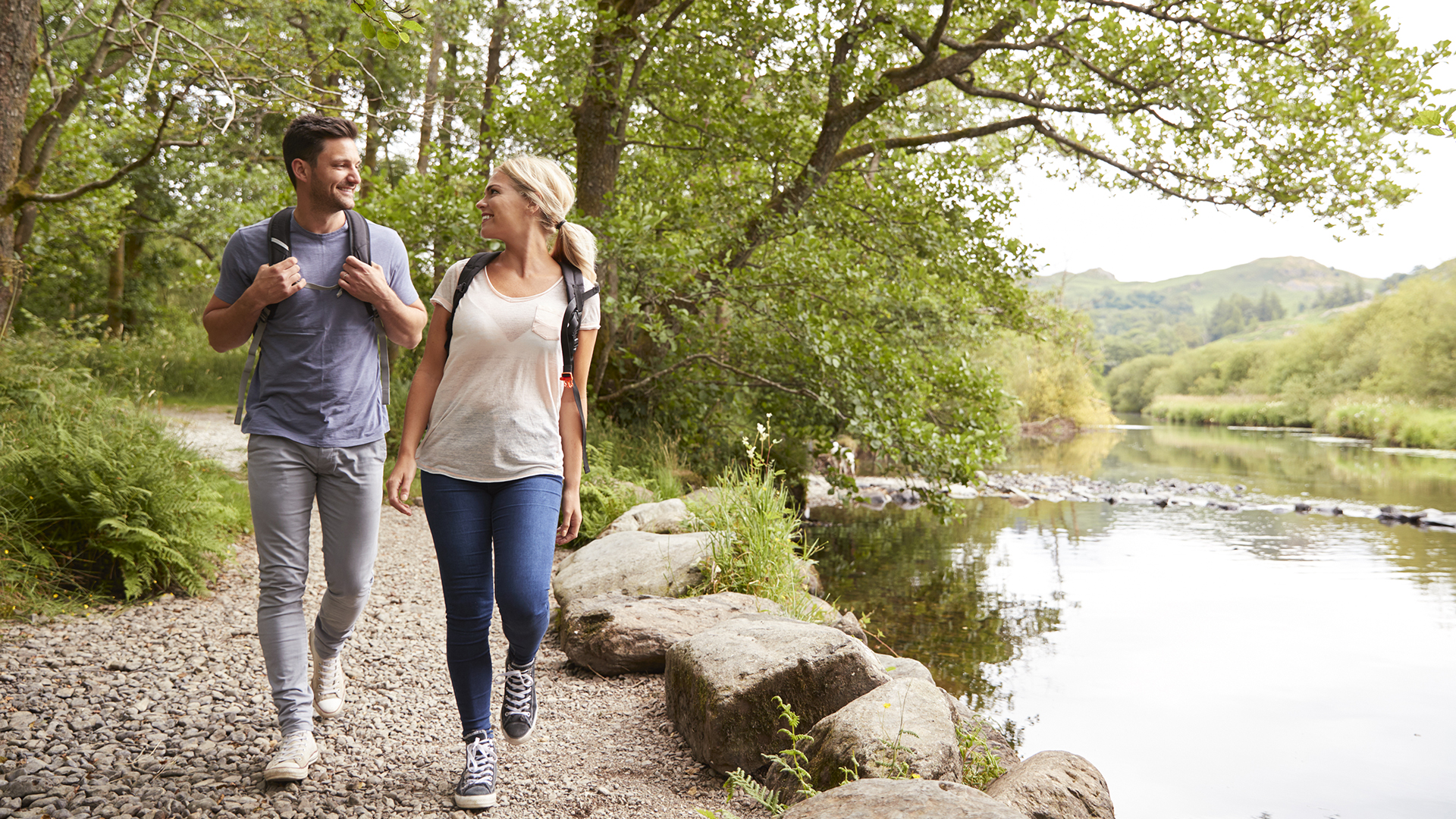 Couple walking along a river