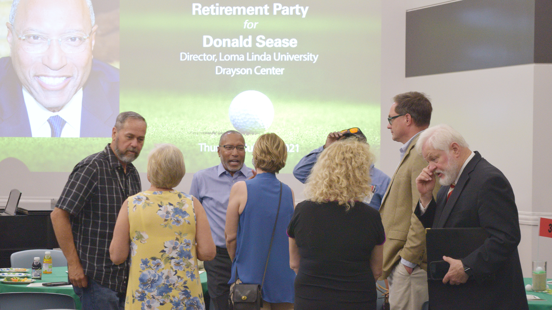 Donald Sease speaks with some of those attending his retirement party.