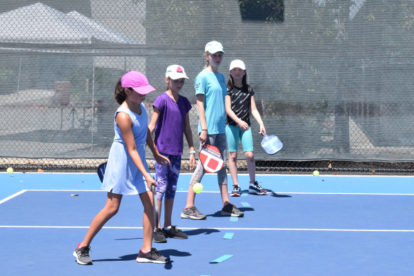 Kids practice serving