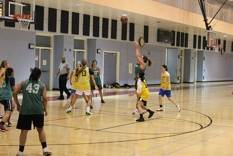 woman basketball player shooting jump shot in a game