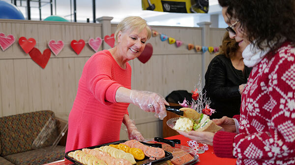 woman serving food to people