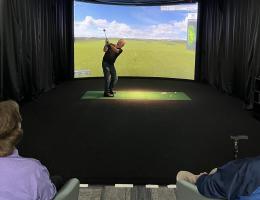 Four golfers tee off at Drayson's Sports Simulator