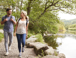 Couple walking along a river