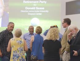 Donald Sease speaks with some of those attending his retirement party.